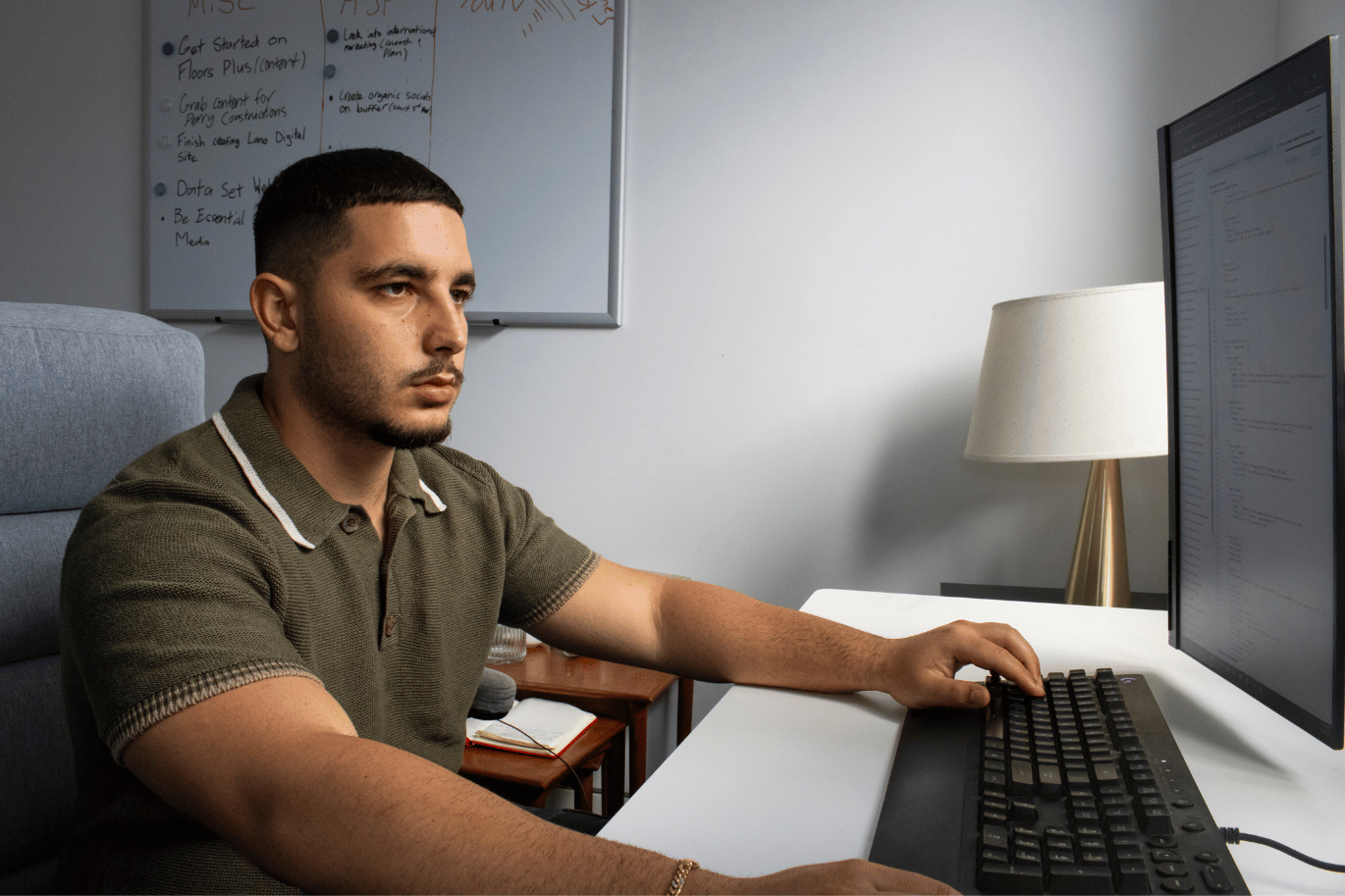 Team member working on a computer near a window